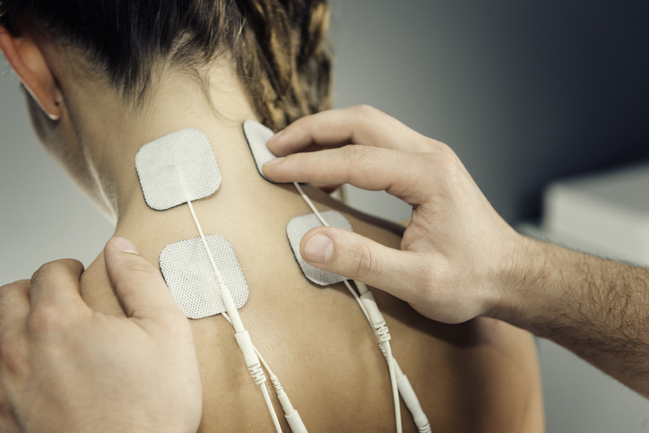 a woman receiving TENS therapy